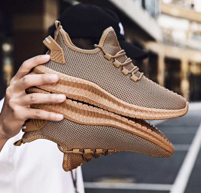 Running Shoes Sneakers Casual Men's Outdoor Athletic Jogging Sports in stylish brown design held in hand.