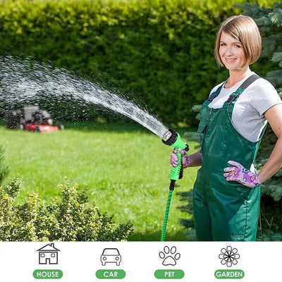 Expanding Expandable Flexible Garden Water Hose w Spray Nozzle 25, 50 in use for watering plants in the garden.