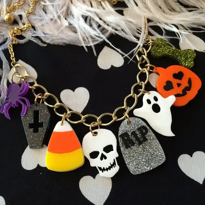 Halloween Accent Charm - Necklace featuring spooky charms like skull, pumpkin, ghost, and candy corn on a gold chain.