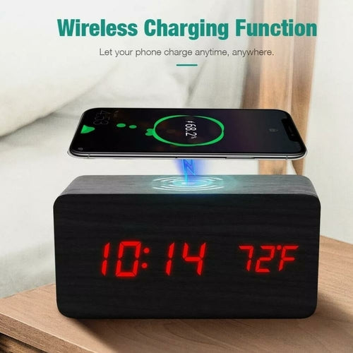 A modern digital alarm clock with a black wooden finish,