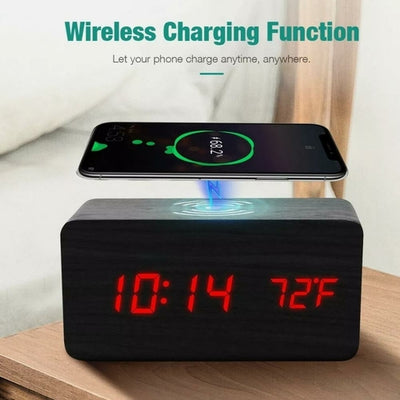 A modern digital alarm clock with a black wooden finish,