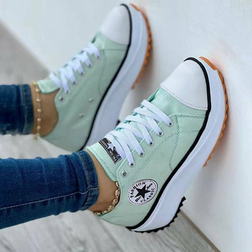 Flat Lace-Up Sneakers Pattern Canvas Casual Sport Shoes in mint green color stylishly worn with denim jeans.