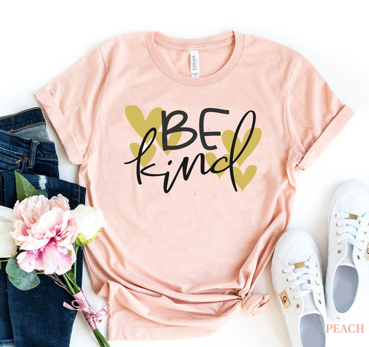 Be Kind T-shirt displayed with floral arrangements and casual outfit, made of premium quality ring spun cotton.