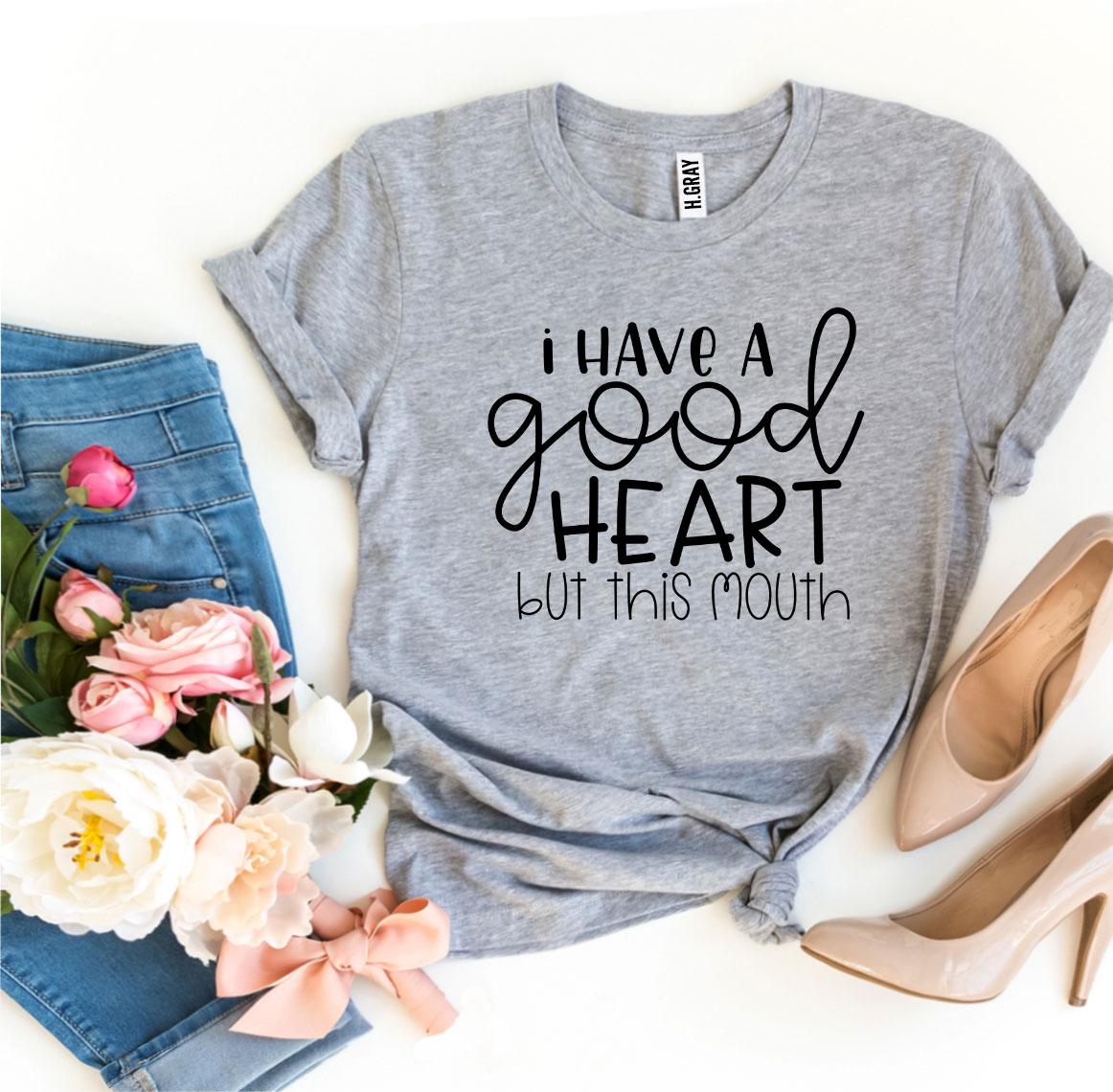 I Have a Good Heart But This Mouth T-shirt displayed with flowers and pants, showcasing stylish design and comfort.