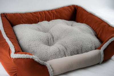 Soft Touch All Seasons 26'' Bed featuring plush gray cushioning and cozy orange exterior for pets.