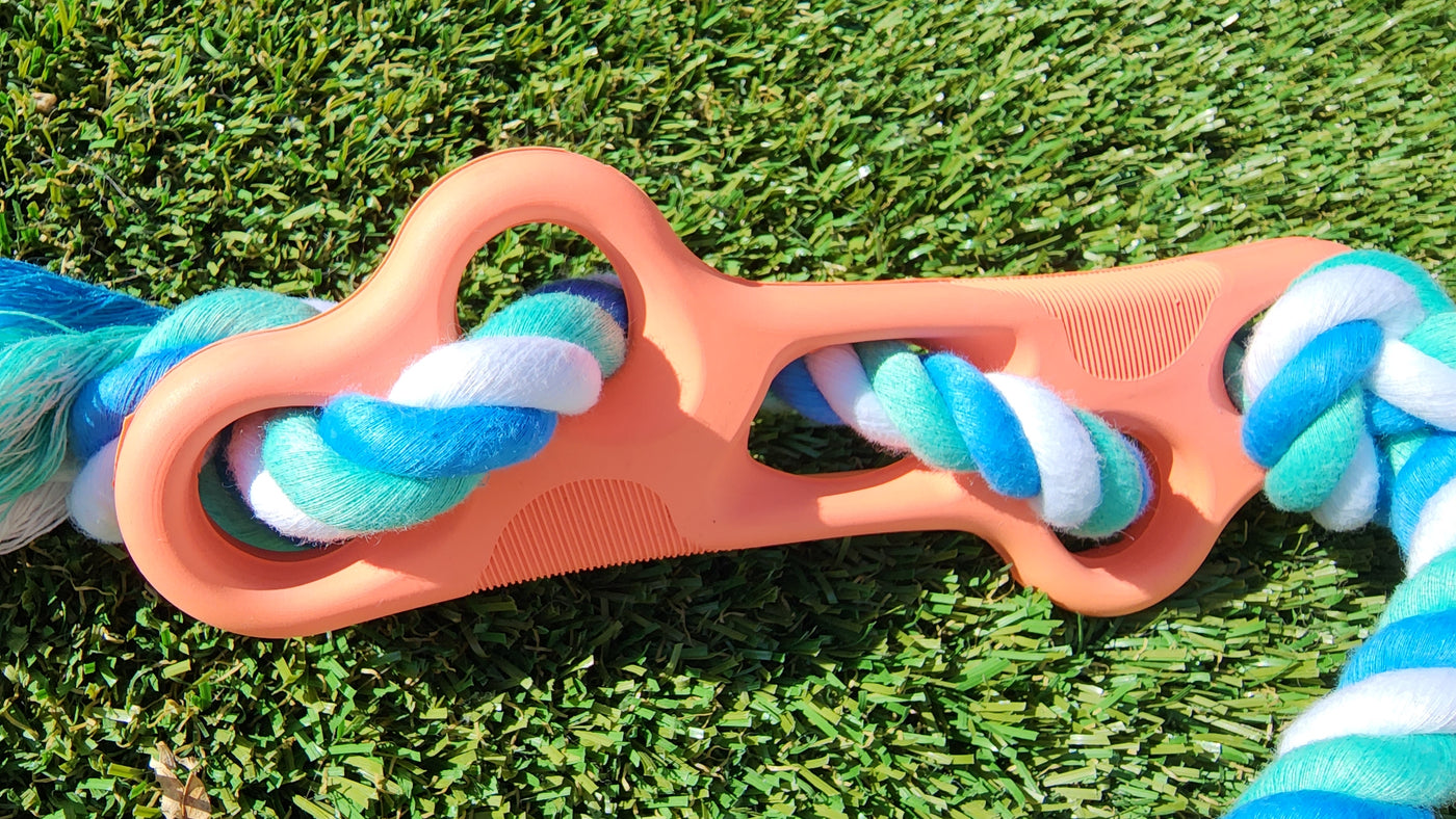 Rubber Bone Dog Chew Toy with Tug Rope -- Great for Active Dogs on grass